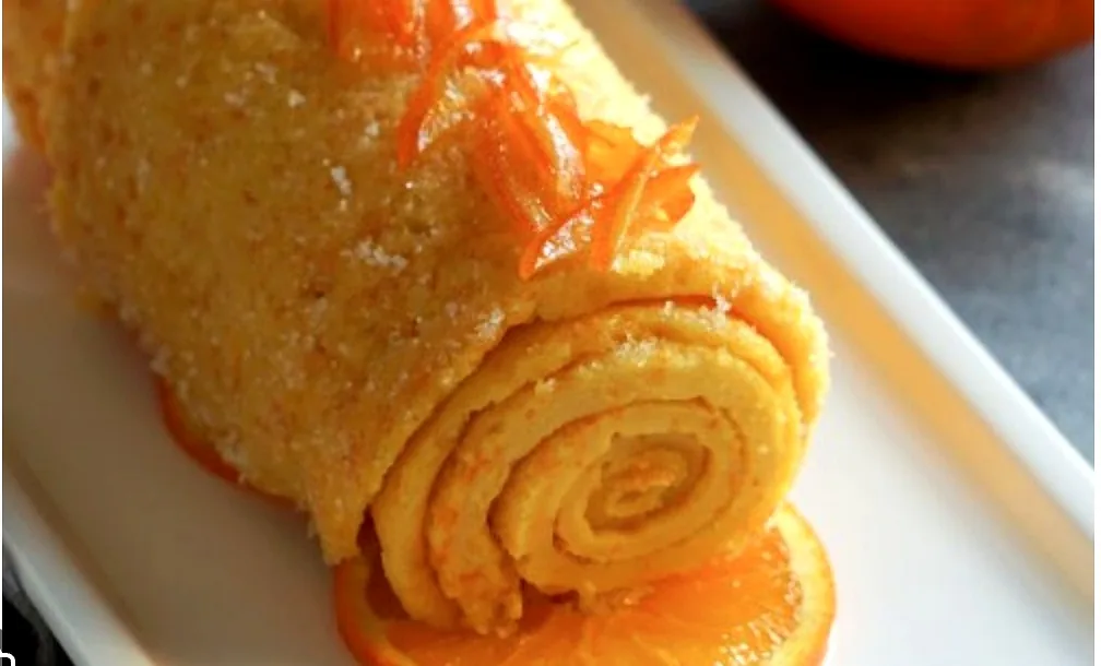 A slice of traditional Algarve orange roll dusted with sugar
