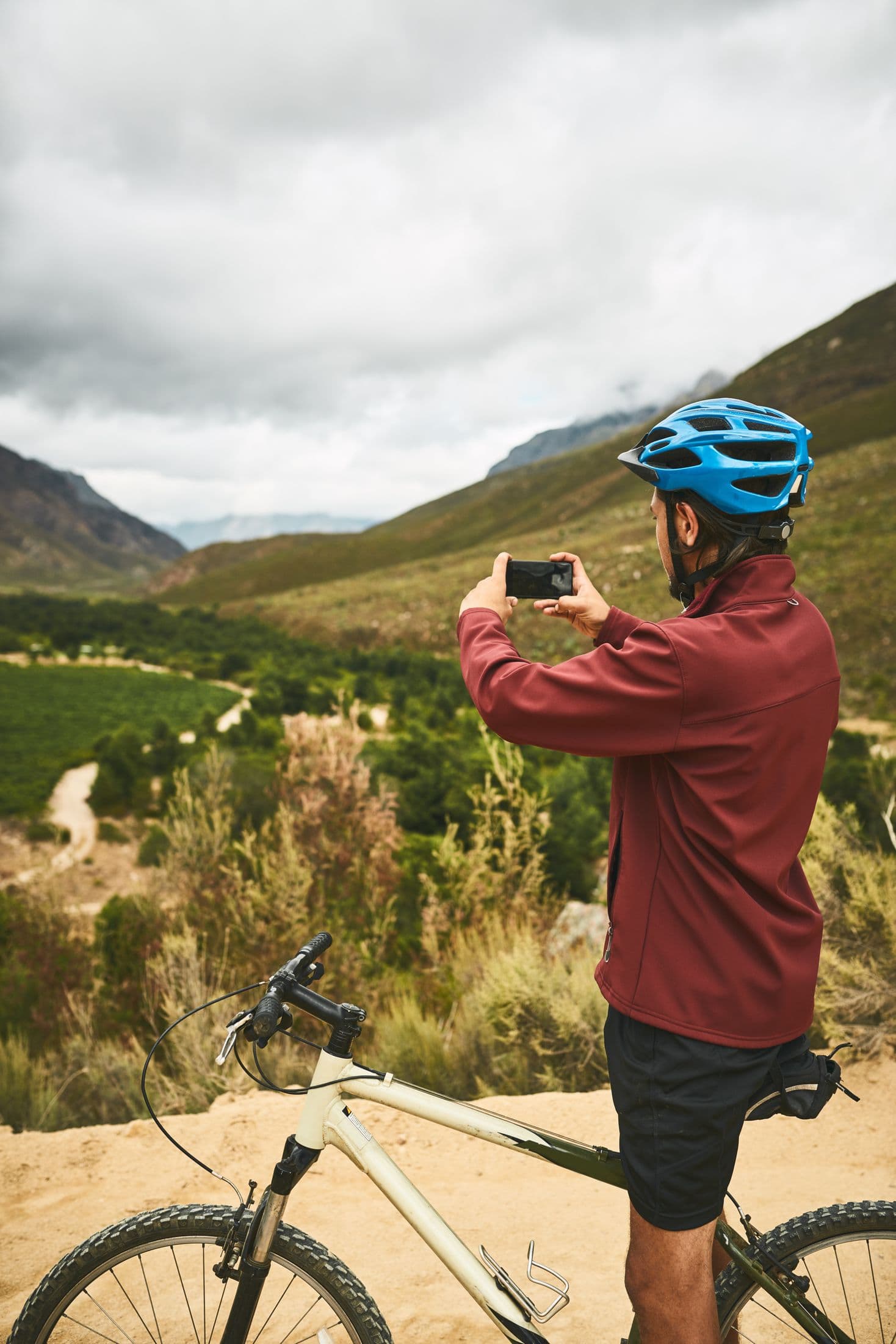 A cyclist pausing on a quiet mountain road to take in the view